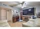 Living room with large TV, comfy sofas, and ceiling fan at 2608 Spear St, North Las Vegas, NV 89030