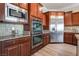 Modern kitchen with stainless steel appliances and wood cabinets at 2837 Josephine Dr, Henderson, NV 89044