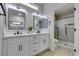 Modern bathroom with double vanity, quartz countertops, and a walk-in shower at 2905 Legend Dr, Las Vegas, NV 89134