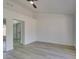 Bright bedroom featuring wood-look flooring and mirrored closet doors at 2905 Legend Dr, Las Vegas, NV 89134