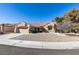 Single-story home with a red tile roof and landscaped front yard at 2905 Legend Dr, Las Vegas, NV 89134