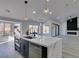 Modern kitchen with white cabinets, marble island, and high-end appliances at 2905 Legend Dr, Las Vegas, NV 89134