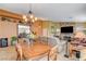 Combined dining and living room with wood table and fireplace at 301 Salinas Dr, Henderson, NV 89014