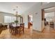 Bright dining room features a wooden table with chairs and a view into the kitchen at 301 Salinas Dr, Henderson, NV 89014