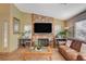 Spacious living room with a stone fireplace and large TV at 301 Salinas Dr, Henderson, NV 89014