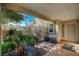 Covered patio with tile flooring, potted plants, and a trellis at 301 Salinas Dr, Henderson, NV 89014