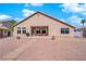 Backyard view showing a large covered patio and desert landscaping at 319 Hidden Highlands Dr, Las Vegas, NV 89110