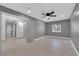 Bedroom with gray walls, ceiling fan and access to hallway at 319 Hidden Highlands Dr, Las Vegas, NV 89110