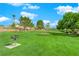 Community area with grassy lawn, picnic table, and grill at 319 Hidden Highlands Dr, Las Vegas, NV 89110