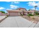 Single-story house with a tan exterior, a two-car garage, and a landscaped front yard at 319 Hidden Highlands Dr, Las Vegas, NV 89110