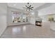 Spacious living room with tile flooring, a fireplace, and large windows at 319 Hidden Highlands Dr, Las Vegas, NV 89110