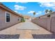 Side yard with concrete patio and stone pathway at 319 Hidden Highlands Dr, Las Vegas, NV 89110