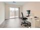 Bright home office with wood-look floors, sliding door to patio, and workspace at 3772 Brilliant Sunset St, Las Vegas, NV 89129