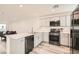 Modern kitchen with gray cabinets, stainless steel appliances, and quartz countertops at 3772 Brilliant Sunset St, Las Vegas, NV 89129