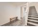 Modern staircase with wood bench at the base and light gray carpeting at 3772 Brilliant Sunset St, Las Vegas, NV 89129