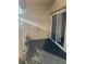 Private balcony with sliding glass doors and plants at 3810 Wiggins Bay St # 203, Las Vegas, NV 89129