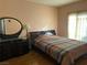 Bedroom with wood floors, large bed, and dresser at 3810 Wiggins Bay St # 203, Las Vegas, NV 89129