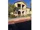 Two-story stucco building with balconies and arched entryways at 3810 Wiggins Bay St # 203, Las Vegas, NV 89129