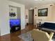 Living area with hardwood floors and TV at 3810 Wiggins Bay St # 203, Las Vegas, NV 89129