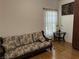 Living room with sofa, wood floors, and a large window at 3810 Wiggins Bay St # 203, Las Vegas, NV 89129