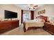 Primary bedroom with king bed, dresser and access to balcony at 3975 N Hualapai Way # 157, Las Vegas, NV 89129