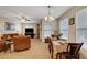 Dining area with a table, chairs, and a light beige tablecloth at 3975 N Hualapai Way # 157, Las Vegas, NV 89129