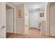 A well-lit hallway with doors to bedrooms and a bathroom at 3975 N Hualapai Way # 157, Las Vegas, NV 89129