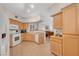 Kitchen features white appliances and light wood cabinets at 3975 N Hualapai Way # 157, Las Vegas, NV 89129