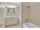 Bathroom with beige tile and vanity with mirror at 4475 El Carnal Way, Las Vegas, NV 89121