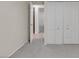 Bedroom with gray carpet, double door closet and window at 4475 El Carnal Way, Las Vegas, NV 89121