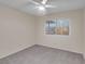 Bedroom with gray carpet, ceiling fan and window at 4475 El Carnal Way, Las Vegas, NV 89121