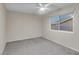 Bedroom with gray carpet, ceiling fan and window at 4475 El Carnal Way, Las Vegas, NV 89121