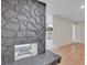 Living room with stone fireplace and wood flooring at 4475 El Carnal Way, Las Vegas, NV 89121