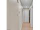 Long hallway with light walls and wood flooring at 4475 El Carnal Way, Las Vegas, NV 89121