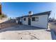 View of the home's backyard, featuring a large concrete patio and a grassy area at 4476 Avondale Ave, Las Vegas, NV 89121