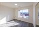 Bright bedroom with large window, gray flooring, and mirrored closet at 4476 Avondale Ave, Las Vegas, NV 89121