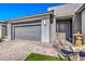 Modern home exterior with a two-car garage and stone accents at 4720 E Cactus Canyon Dr, Pahrump, NV 89061