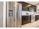 Modern kitchen with stainless steel appliances and dark wood cabinets at 4720 E Cactus Canyon Dr, Pahrump, NV 89061