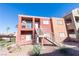 Two-story stucco building with stairs and desert landscaping at 4730 E Craig Rd # 2028, Las Vegas, NV 89115