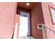 Inviting condo entrance with a white door and red building exterior at 4730 E Craig Rd # 2028, Las Vegas, NV 89115