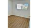 Well-lit bedroom, featuring wood-look flooring and a window at 5116 Golden Ln # A, Las Vegas, NV 89119