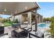 Covered patio with fire pit, dining area, and pool view at 5167 Rock Daisy Dr, Las Vegas, NV 89135