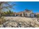 Spacious backyard featuring desert landscaping, block wall, and a covered patio area at 5624 Silver Belle St, Las Vegas, NV 89149