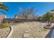 Large backyard with desert landscaping and a brick-paved patio area at 5624 Silver Belle St, Las Vegas, NV 89149