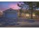 Single-story home with attached two-car garage beneath a dusk sky at 5624 Silver Belle St, Las Vegas, NV 89149