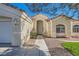 Inviting front entrance with tiled roof, desert landscaping, and a walkway leading to the front door at 5624 Silver Belle St, Las Vegas, NV 89149