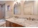 Elegant bathroom with double sinks, marble countertop, and gold fixtures at 5750 Edna Ave, Las Vegas, NV 89146