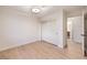 Bedroom with light wood floors and a view of the bathroom at 5750 Edna Ave, Las Vegas, NV 89146