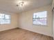 Bright bedroom with light wood floors and large windows at 5750 Edna Ave, Las Vegas, NV 89146