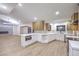 Modern kitchen with island, white cabinets, and hardwood floors at 5750 Edna Ave, Las Vegas, NV 89146